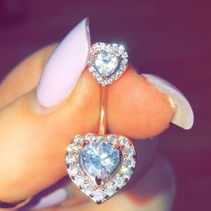 Rose gold belly button ring.